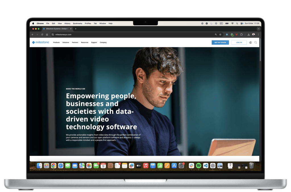Milestone Systems homepage on a laptop screen